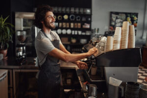 Happy barista making coffee and espresso